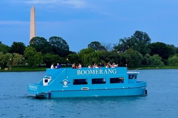 a blue and white boat floating on a large body of water