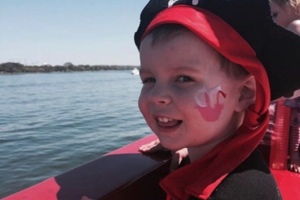 a little boy that is sitting in the water