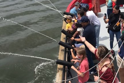 a group of people riding on the back of a boat