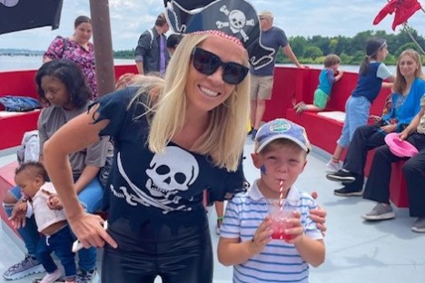 a mother and son posing for a photo on a pirate ship