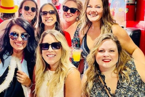 women posing for a photo on a boat