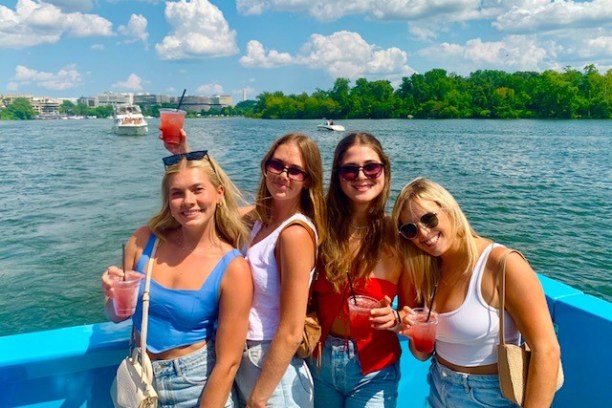 a group of people standing next to a body of water