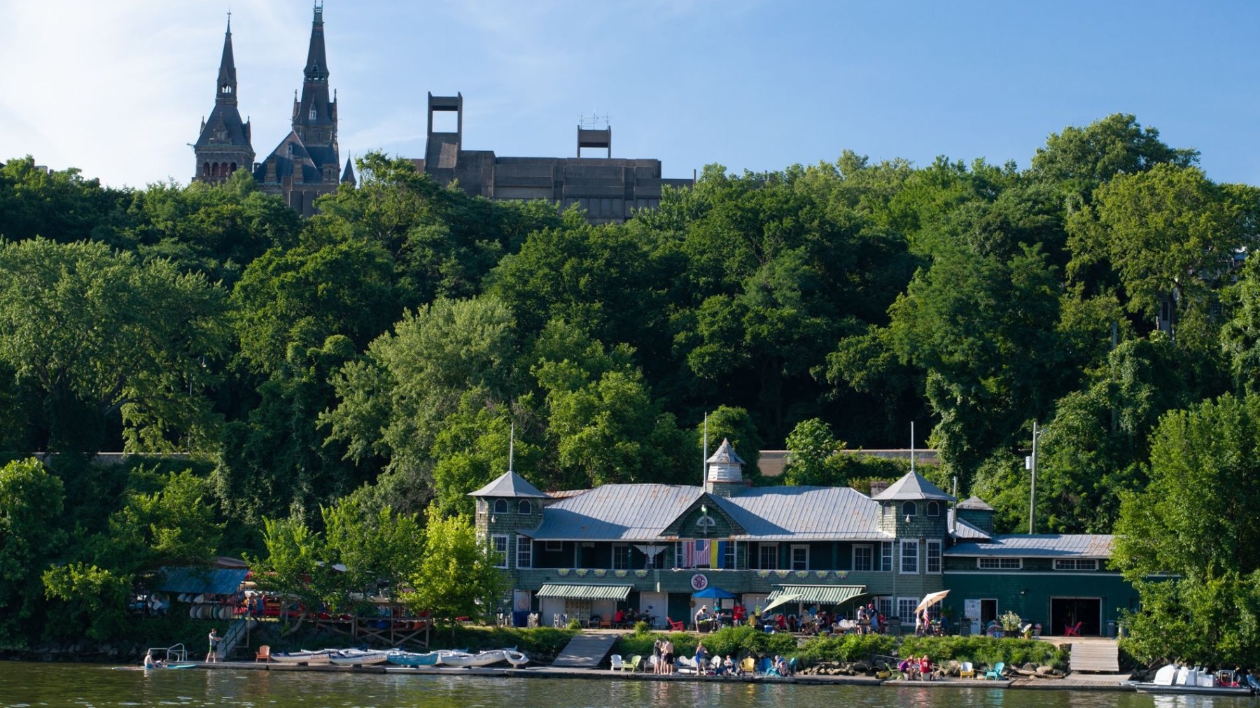 a boat floating along a river next to a body of water