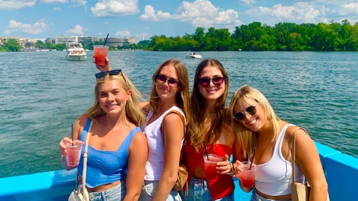 a group of people standing next to a body of water