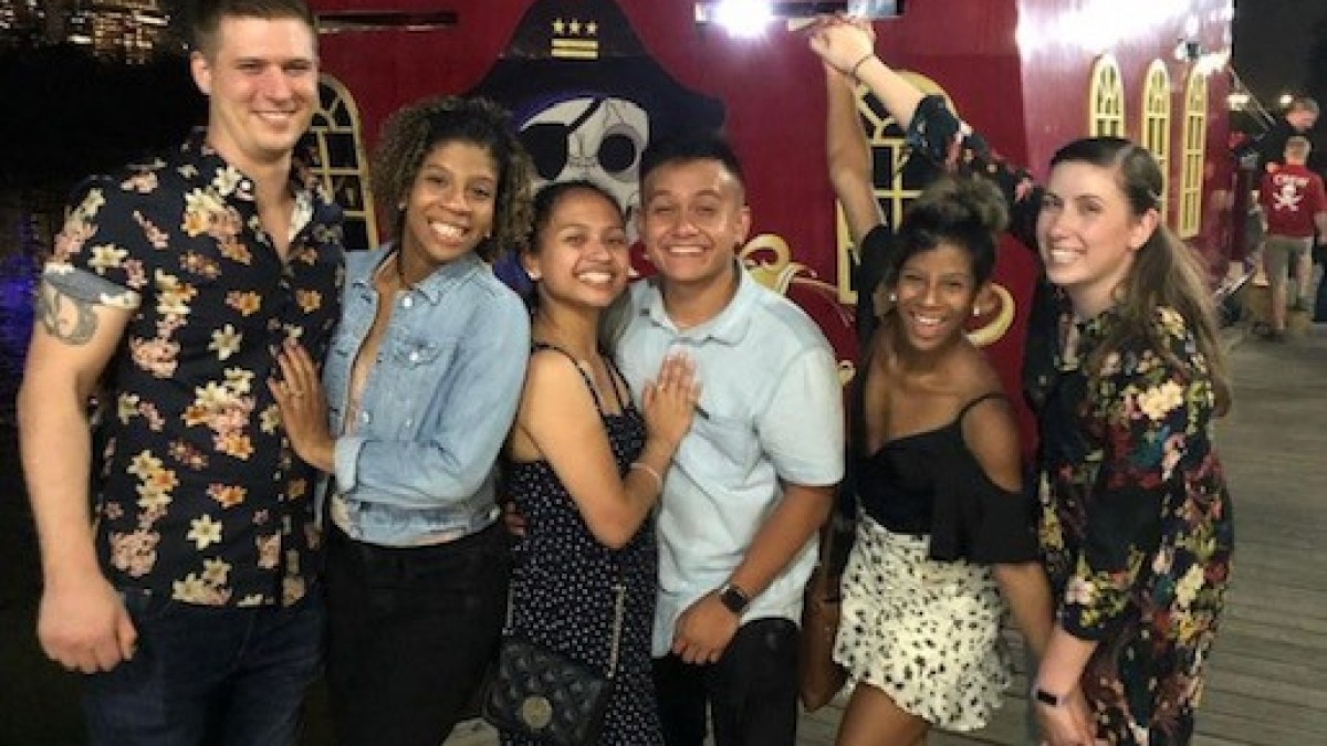 a group of people standing in front of a crowd posing for the camera